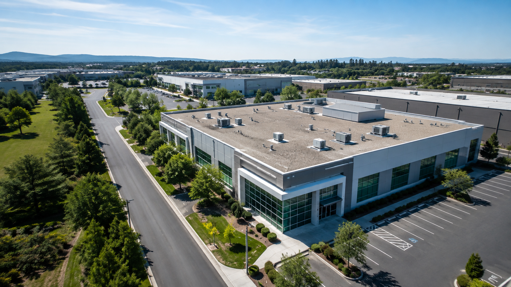 Aerial view of a modern commercial and industrial property in a business park.
